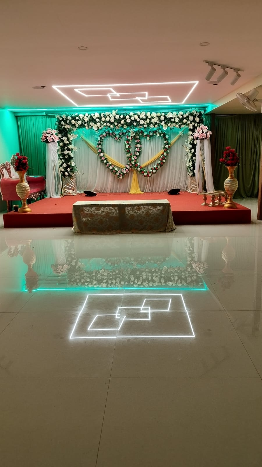 Elegant decorated stage inside the Uday Comforts event hall