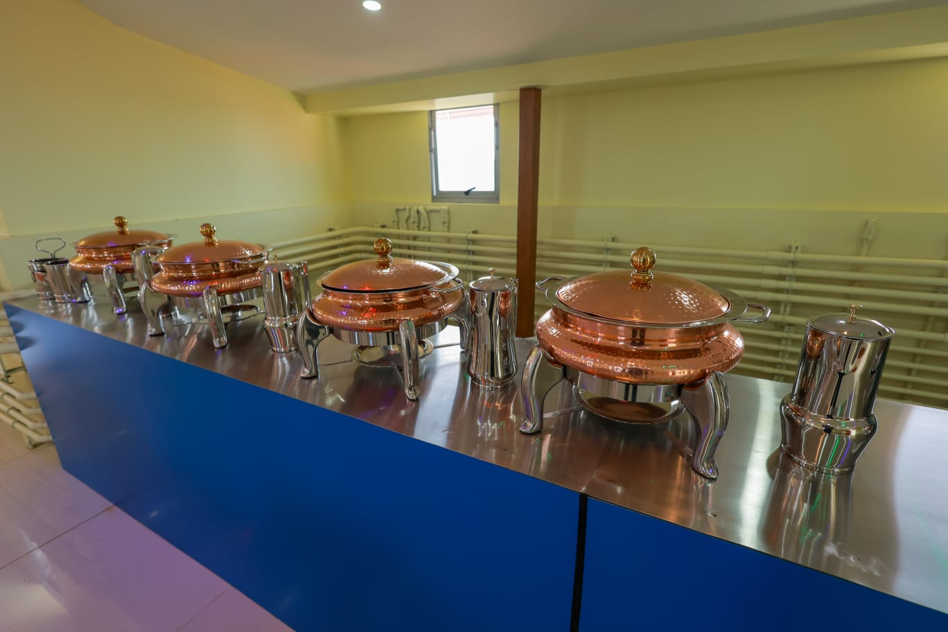 Buffet counter set with copper chafing dishes and serving vessels