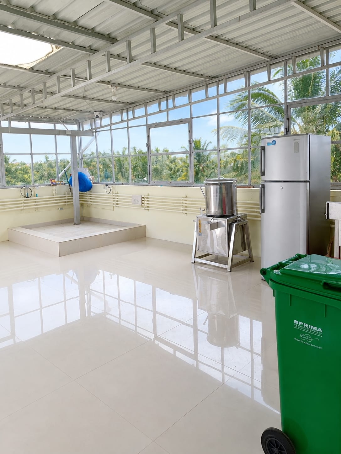 Bright rooftop catering kitchen with glass walls and stainless steel equipment